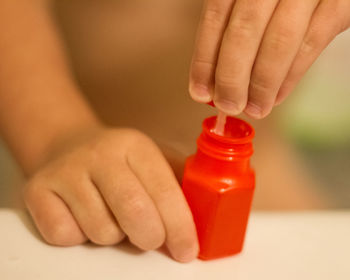 Close-up of hand holding bottle