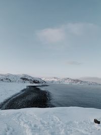 Scenic view of frozen lake against sky during winter