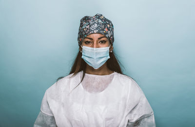 Portrait of woman against blue background