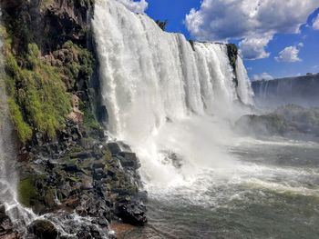 Scenic view of waterfall against sea