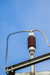 Low angle view of electric light against sky