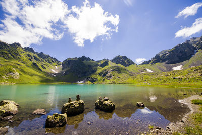 Alpine mountain lake at the daytime, sunlight and colorful landscape of golden water lake 