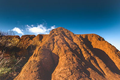 Scenic view of mountains against blue sky