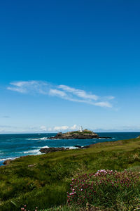 Scenic view of sea against blue sky