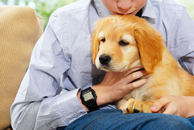 Midsection of boy with puppy