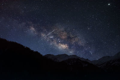 Milky way galaxy photography at dramatic night sky with star trail and shooting star