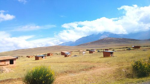 Houses on field against sky