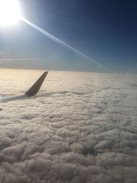 Airplane flying over cloudscape against sky