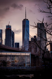 Buildings in city against cloudy sky