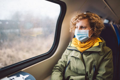 Portrait of woman seen through car window