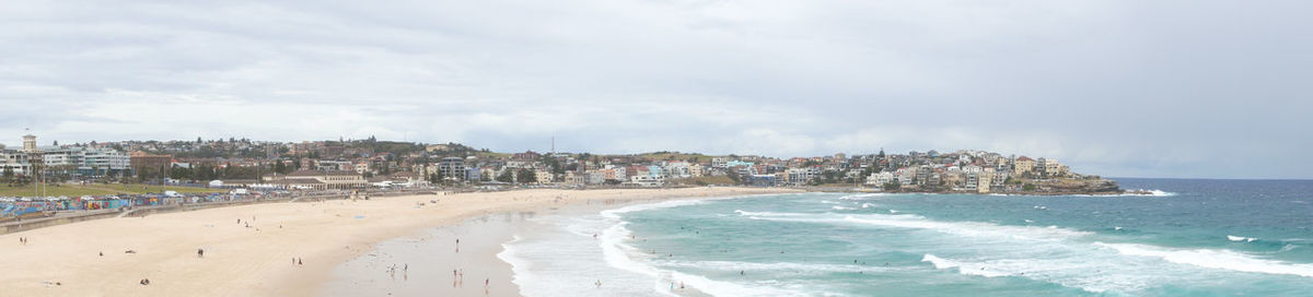 Panoramic view of beach and buildings against sky