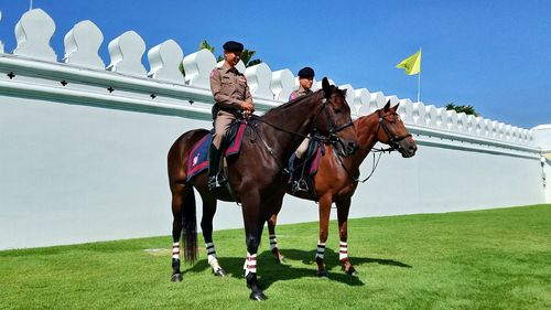 Men riding horse