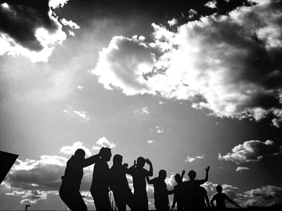 sky, leisure activity, lifestyles, cloud - sky, men, togetherness, sunlight, person, cloud, low angle view, standing, sun, cloudy, sunbeam, nature, outdoors, day, large group of people