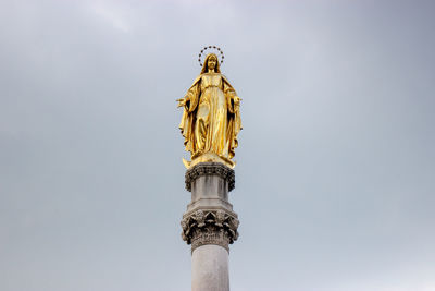 Low angle view of statue of liberty against sky