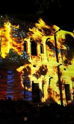 Low angle view of illuminated building at night