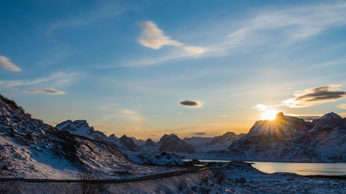 Scenic view of snow covered mountains against sky during sunset