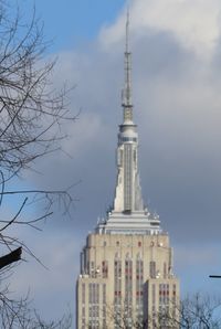 Low angle view of buildings against cloudy sky