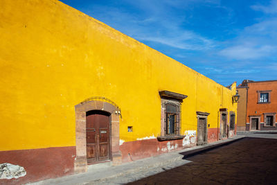 Yellow building against sky