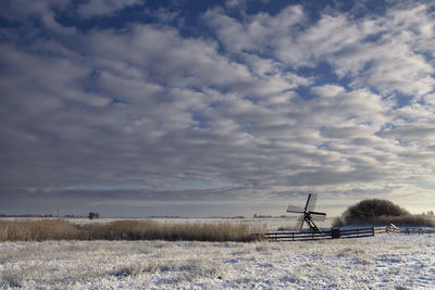 Scenic view of snowy field against sky