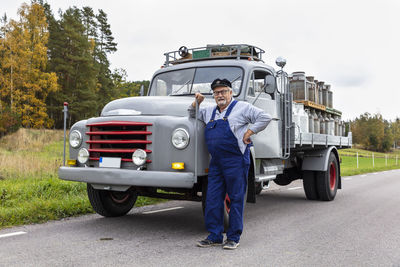 Milk man standing in front of milk van