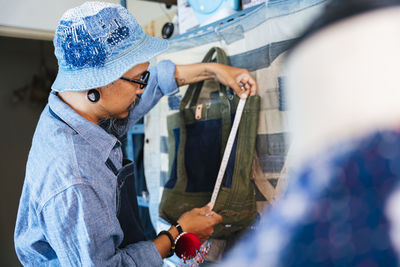 Man working over fabric on table