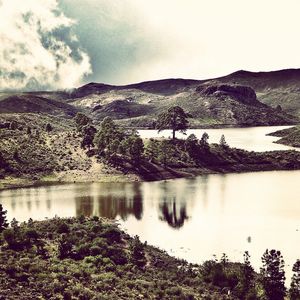 Scenic view of lake with mountains in background