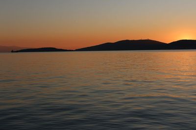 Scenic view of sea against orange sky