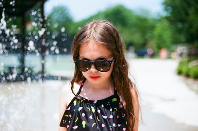 Portrait of cute girl wearing sunglasses during sunny day
