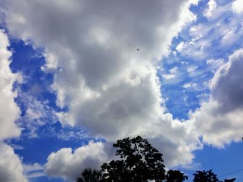 Low angle view of silhouette trees against sky