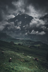 Scenic view of field and mountains against sky