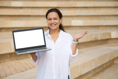Portrait of young businesswoman using digital tablet