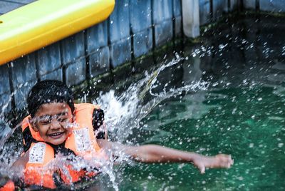 Portrait of smiling boy in swimming pool