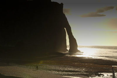 Close-up of silhouette rock against sky at sunset