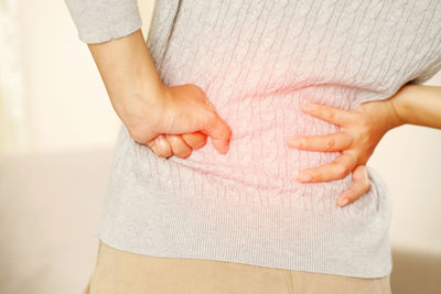 Midsection of couple holding hands