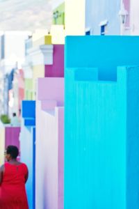 Rear view of woman standing against multi colored wall