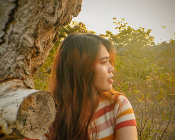 Portrait of beautiful young woman looking away