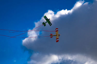 Low angle view of airplane flying against sky