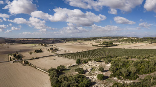 High angle view of road amidst field against sky