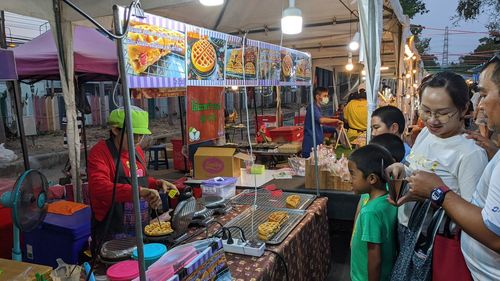 Group of people at market stall