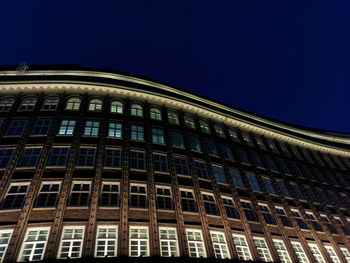 Low angle view of building against clear sky at night