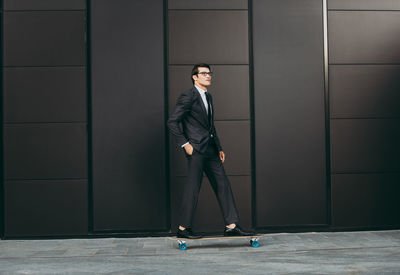 Full length of a young man on wall