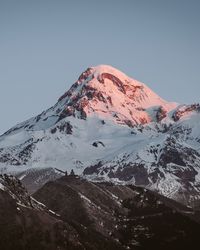 Scenic view of snowcapped mountains against clear sky