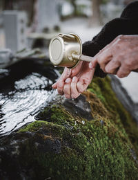 A hand shot of old lady washing her hands in japanese temple