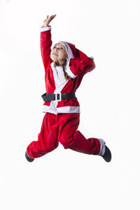 Full length of young woman jumping against white background