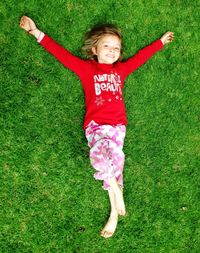 Cute girl sitting on footpath in park