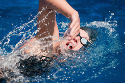 High angle view of child swimming in pool