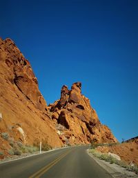 Scenic view of mountain road against clear sky