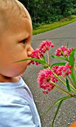 Close-up of boy with flowers in park