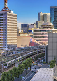 Aerial view of buildings in city against sky