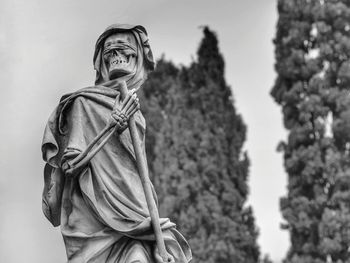 Low angle view of statue against sky